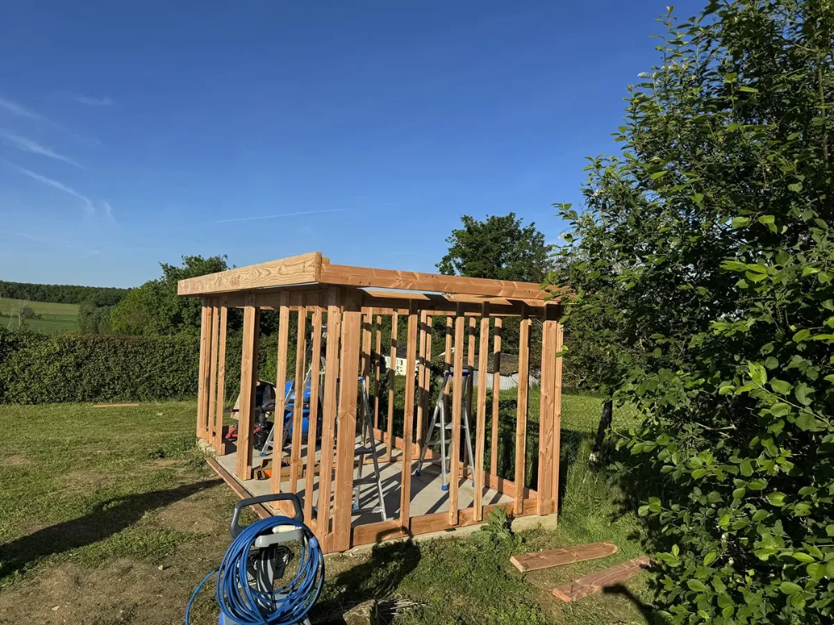 Ossature en bois d'un abri de jardin montée sur une dalle béton, charpente monopente en place
